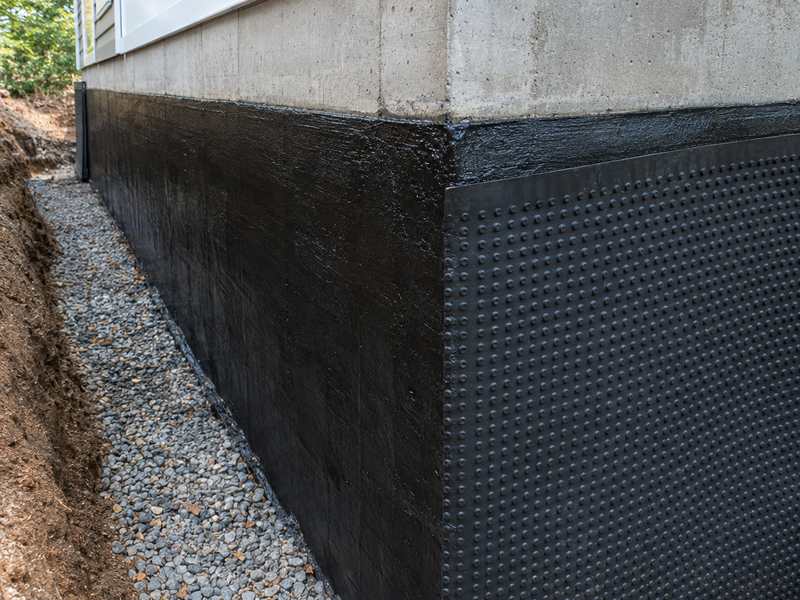 Foundation waterproofing coating on a concrete foundation wall in Asheville, NC